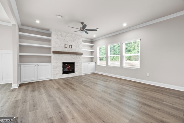 272 Broadstone Blvd, Acworth, GA 30101 - unfurnished living room with a ceiling fan, crown molding, light wood-style floors, baseboards, and a fireplace