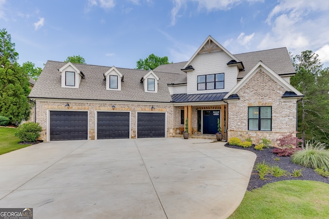 4781 Falling Brook Dr, Flowery Branch, GA 30542 - view of front facade with an attached garage, driveway, a shingled roof, brick siding, and a standing seam roof