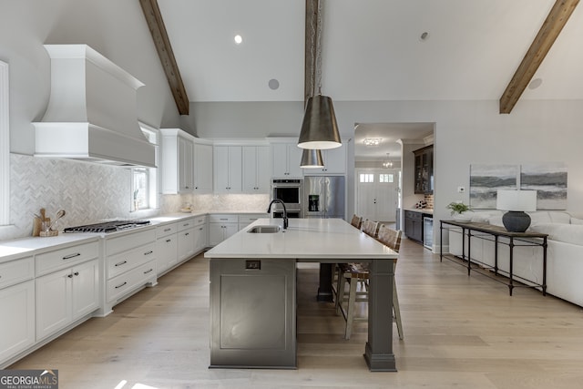 4781 Falling Brook Dr, Flowery Branch, GA 30542 - kitchen with stainless steel appliances, a sink, custom exhaust hood, backsplash, and healthy amount of natural light