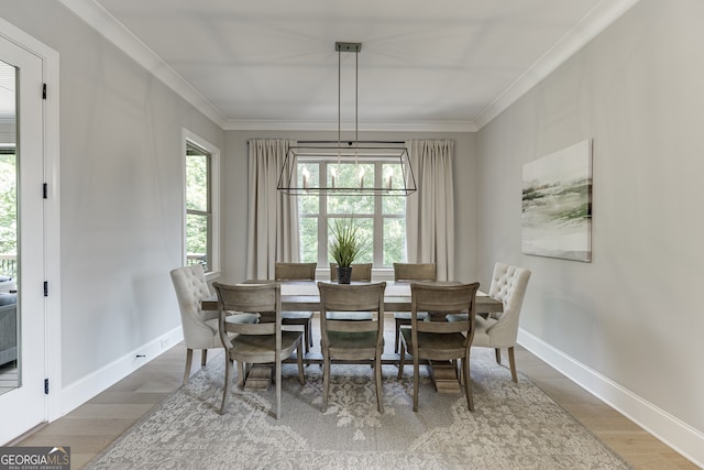 4781 Falling Brook Dr, Flowery Branch, GA 30542 - dining space with wood finished floors, baseboards, and crown molding