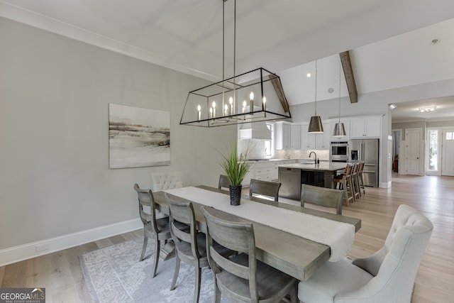 4781 Falling Brook Dr, Flowery Branch, GA 30542 - dining area with baseboards, light wood-style flooring, and a chandelier