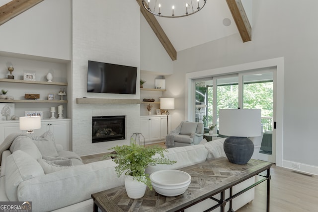 4781 Falling Brook Dr, Flowery Branch, GA 30542 - living area featuring high vaulted ceiling, beam ceiling, light wood-type flooring, a brick fireplace, and baseboards