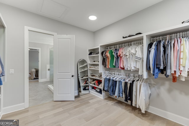 4781 Falling Brook Dr, Flowery Branch, GA 30542 - walk in closet with attic access, wood finished floors, and lofted ceiling