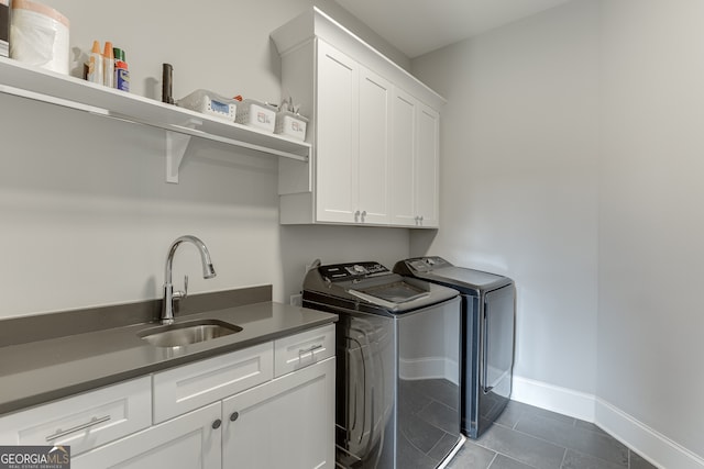 4781 Falling Brook Dr, Flowery Branch, GA 30542 - laundry area featuring cabinet space, washer and dryer, baseboards, and dark tile patterned floors