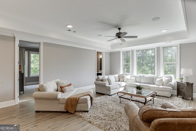 4781 Falling Brook Dr, Flowery Branch, GA 30542 - living area featuring a tray ceiling, healthy amount of natural light, ceiling fan, light wood-type flooring, and recessed lighting