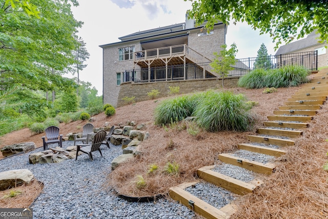 4781 Falling Brook Dr, Flowery Branch, GA 30542 - back of property with stairs and an outdoor fire pit