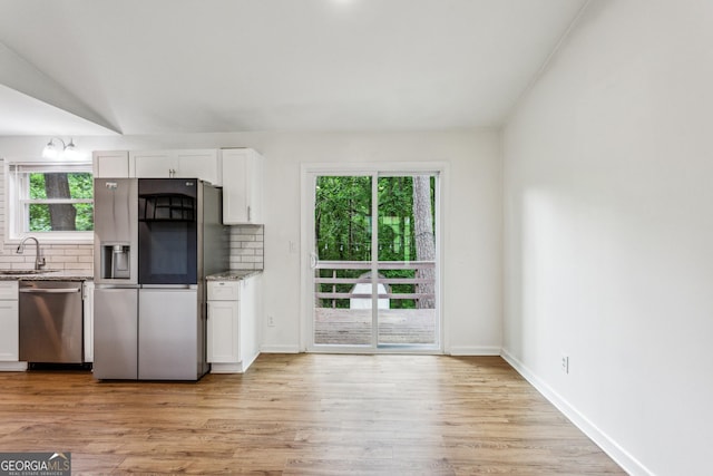 232 Apple Branch Dr, Woodstock, GA 30188 - kitchen featuring appliances with stainless steel finishes, a sink, tasteful backsplash, and white cabinets