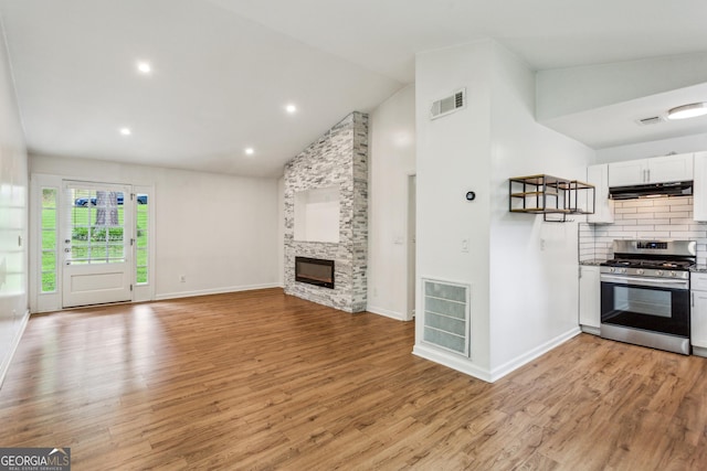 232 Apple Branch Dr, Woodstock, GA 30188 - unfurnished living room featuring light wood finished floors, a fireplace, baseboards, high vaulted ceiling, and recessed lighting