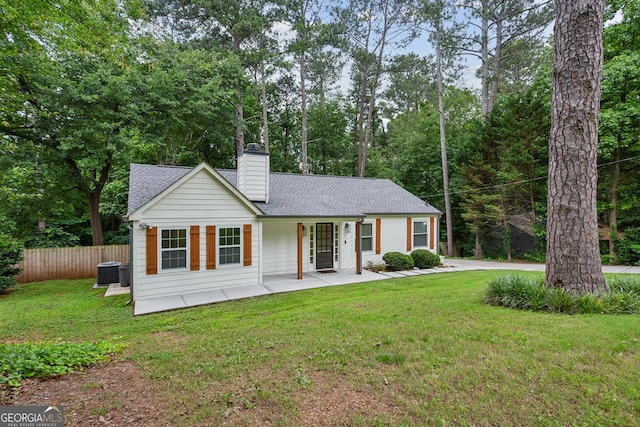 232 Apple Branch Dr, Woodstock, GA 30188 - view of front of house with a chimney, a shingled roof, cooling unit, a porch, and view of wooded area