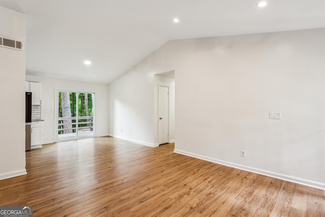 232 Apple Branch Dr, Woodstock, GA 30188 - unfurnished living room featuring light wood finished floors, lofted ceiling, baseboards, and recessed lighting