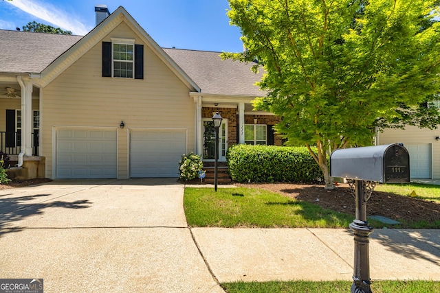 111 Portico Pl, Newnan, GA 30265 - traditional home with a shingled roof, a chimney, a garage, and concrete driveway