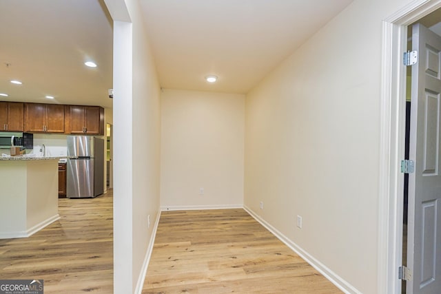 111 Portico Pl, Newnan, GA 30265 - hall with light wood finished floors, recessed lighting, baseboards, and a sink
