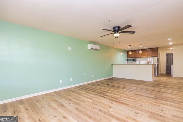 111 Portico Pl, Newnan, GA 30265 - unfurnished living room with an AC wall unit, light wood-style flooring, a ceiling fan, recessed lighting, and baseboards