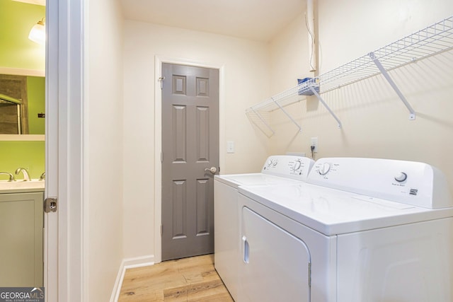 111 Portico Pl, Newnan, GA 30265 - laundry room with independent washer and dryer, light wood finished floors, and baseboards