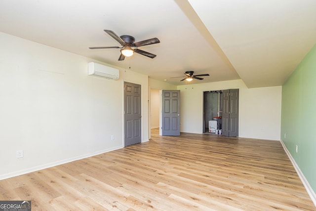 111 Portico Pl, Newnan, GA 30265 - unfurnished room with a wall mounted air conditioner, ceiling fan, light wood-style floors, and baseboards