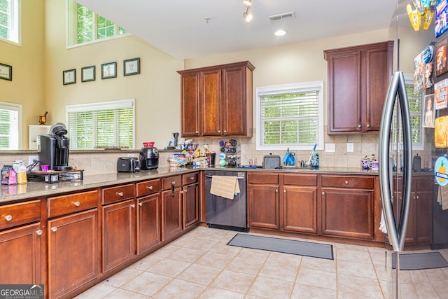 111 Portico Pl, Newnan, GA 30265 - kitchen with dishwashing machine, stainless steel fridge, decorative backsplash, and plenty of natural light