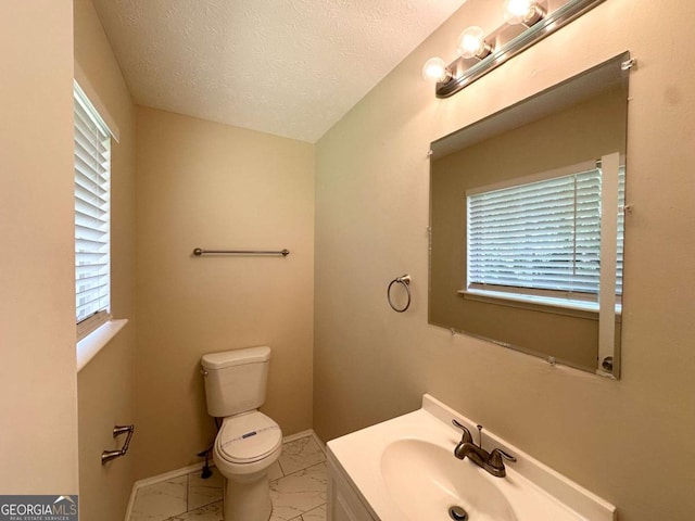 3730 Stephanie Dr SW, Atlanta, GA 30331 - half bathroom with marble look tile flooring, toilet, vanity, healthy amount of natural light, and a textured ceiling