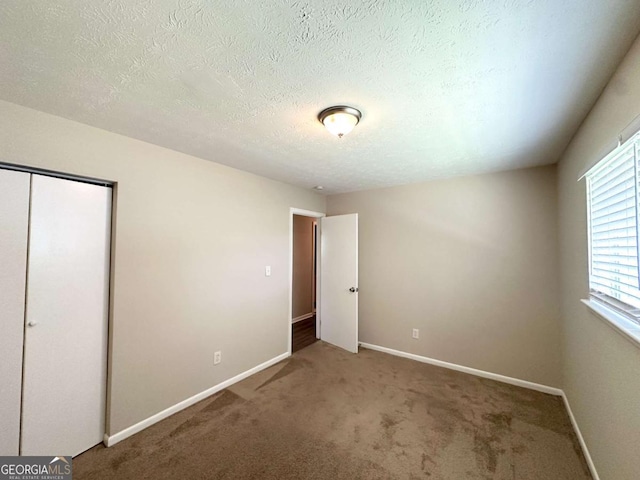 3730 Stephanie Dr SW, Atlanta, GA 30331 - unfurnished bedroom with carpet, baseboards, a closet, and a textured ceiling