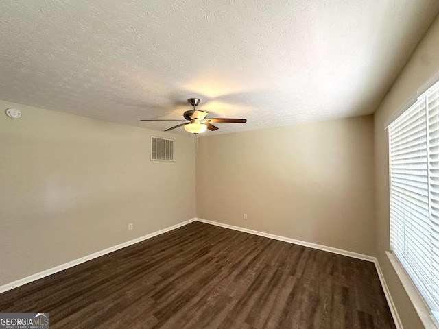 3730 Stephanie Dr SW, Atlanta, GA 30331 - empty room featuring dark wood-style flooring, a ceiling fan, healthy amount of natural light, a textured ceiling, and baseboards