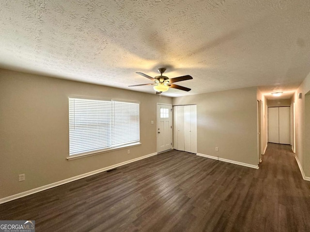 3730 Stephanie Dr SW, Atlanta, GA 30331 - unfurnished living room with dark wood-style floors, a textured ceiling, ceiling fan, and baseboards