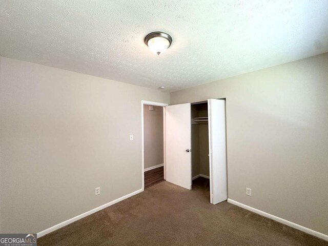 3730 Stephanie Dr SW, Atlanta, GA 30331 - unfurnished bedroom featuring carpet, a closet, baseboards, and a textured ceiling