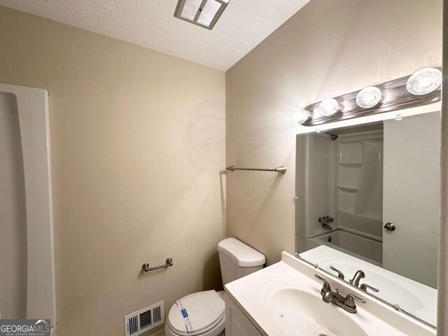 3730 Stephanie Dr SW, Atlanta, GA 30331 - bathroom with toilet, vanity, a textured ceiling, and tub / shower combination