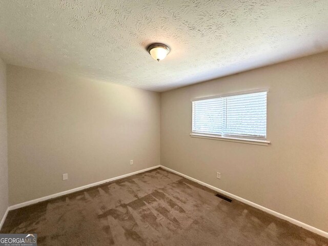 3730 Stephanie Dr SW, Atlanta, GA 30331 - carpeted spare room featuring baseboards and a textured ceiling