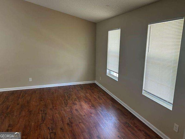 6536 Rebecca Lou Ln, Lithonia, GA 30058 - unfurnished room featuring dark wood-style flooring and a textured ceiling