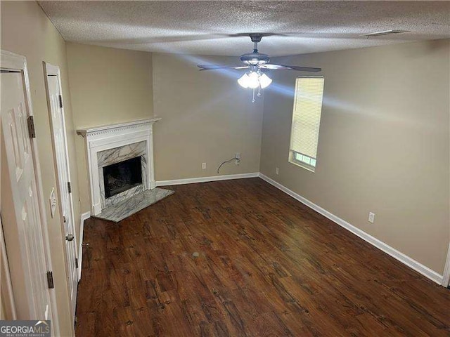 6536 Rebecca Lou Ln, Lithonia, GA 30058 - unfurnished living room featuring a textured ceiling, wood finished floors, a ceiling fan, and a fireplace