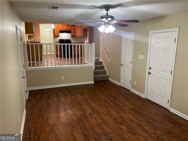 6536 Rebecca Lou Ln, Lithonia, GA 30058 - unfurnished living room featuring dark wood finished floors, ceiling fan, stairway, and a textured ceiling