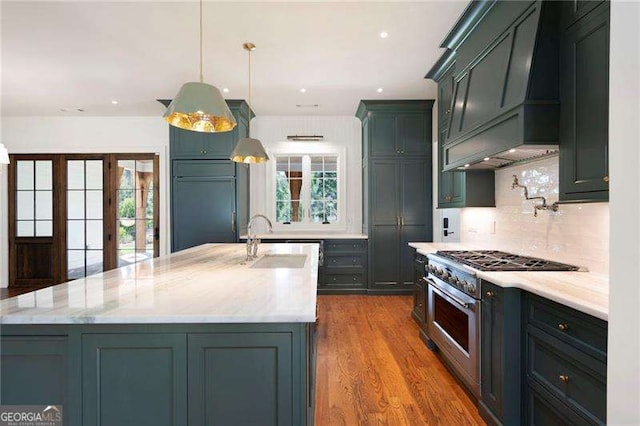 1830 Maple St, Carrollton, GA 30117 - kitchen featuring high end stainless steel range oven, decorative backsplash, light stone counters, a center island with sink, and recessed lighting