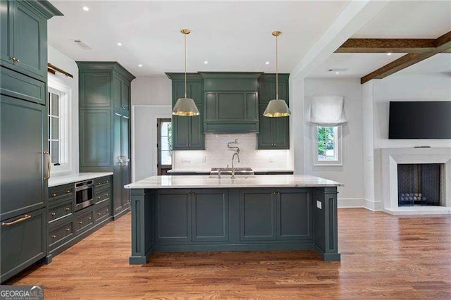 1830 Maple St, Carrollton, GA 30117 - kitchen featuring green cabinets, healthy amount of natural light, light wood finished floors, backsplash, and recessed lighting
