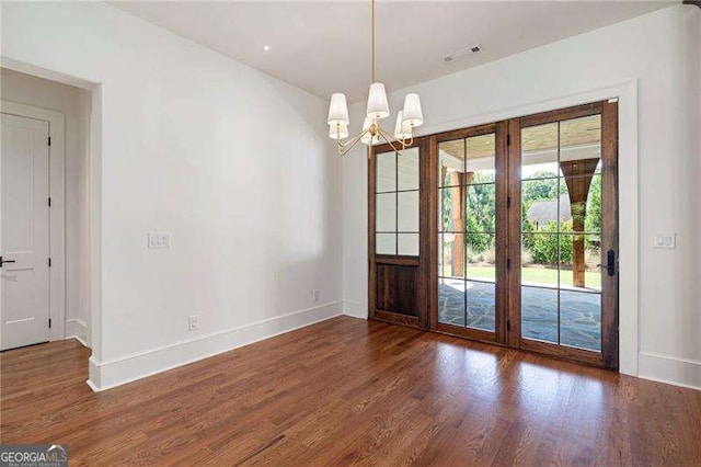 1830 Maple St, Carrollton, GA 30117 - unfurnished dining area featuring wood finished floors, a chandelier, and baseboards