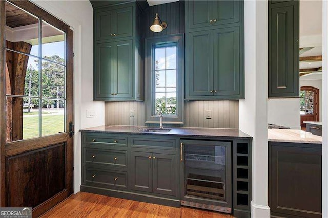1830 Maple St, Carrollton, GA 30117 - bar area featuring wine cooler, a sink, and wood finished floors