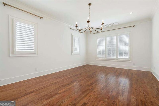 1830 Maple St, Carrollton, GA 30117 - empty room with a chandelier, ornamental molding, dark wood-style floors, and baseboards