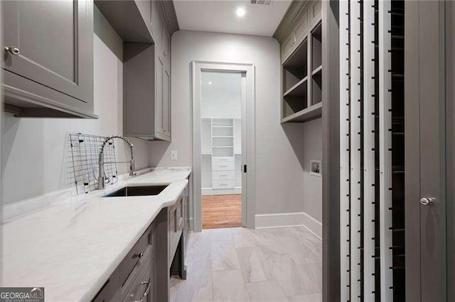 1830 Maple St, Carrollton, GA 30117 - washroom featuring cabinet space, light marble finish flooring, baseboards, and recessed lighting