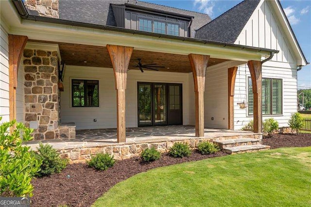 1830 Maple St, Carrollton, GA 30117 - view of exterior entry with board and batten siding, a ceiling fan, a shingled roof, and a lawn