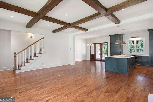 1830 Maple St, Carrollton, GA 30117 - unfurnished living room featuring coffered ceiling, wood finished floors, stairway, baseboards, and beamed ceiling