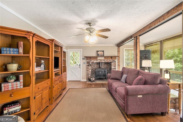 345 Davis Rd W, Fairmount, GA 30139 - living area with a wood stove, a textured ceiling, light wood finished floors, plenty of natural light, and ceiling fan