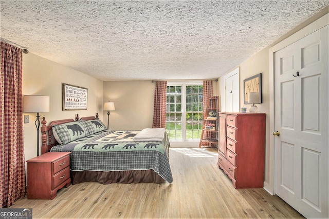 345 Davis Rd W, Fairmount, GA 30139 - bedroom with light wood-style floors and a textured ceiling