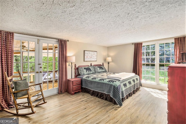 345 Davis Rd W, Fairmount, GA 30139 - bedroom with french doors, wood finished floors, a textured ceiling, and access to outside