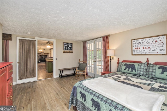 345 Davis Rd W, Fairmount, GA 30139 - bedroom with wood finished floors, french doors, access to outside, a textured ceiling, and baseboards