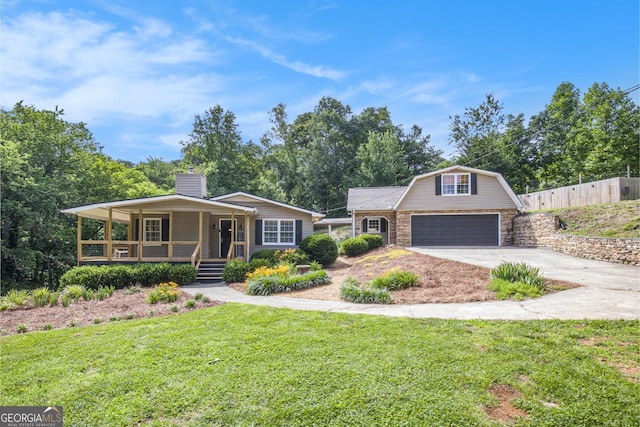 345 Davis Rd W, Fairmount, GA 30139 - view of front of home featuring covered porch, driveway, a chimney, an outdoor structure, and stone siding