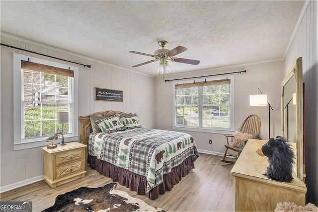 345 Davis Rd W, Fairmount, GA 30139 - bedroom featuring ornamental molding, light wood finished floors, baseboards, a ceiling fan, and a textured ceiling