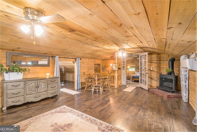 345 Davis Rd W, Fairmount, GA 30139 - dining area featuring a ceiling fan, a wood stove, wooden walls, wood ceiling, and lofted ceiling