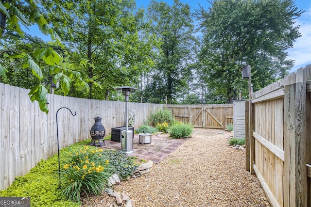 345 Davis Rd W, Fairmount, GA 30139 - fenced backyard with a gate and a patio