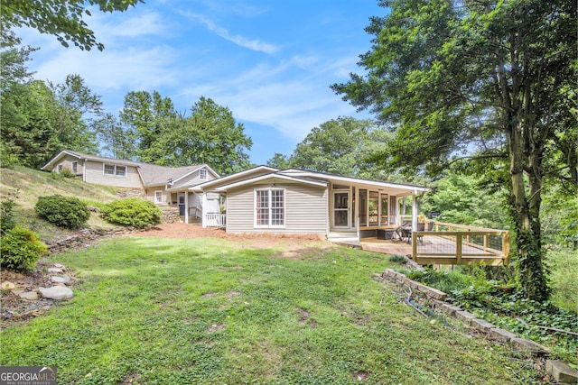 345 Davis Rd W, Fairmount, GA 30139 - back of house with a yard, a wooden deck, and a sunroom