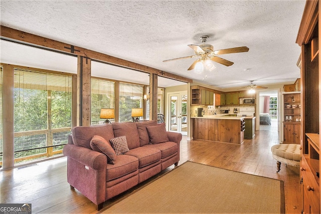 345 Davis Rd W, Fairmount, GA 30139 - living area featuring light wood finished floors, ceiling fan, and a textured ceiling