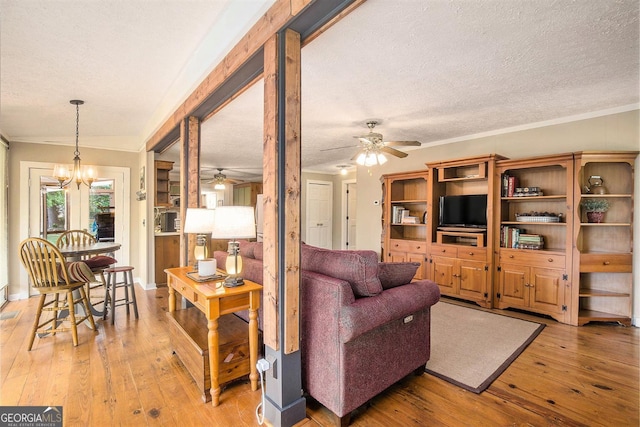 345 Davis Rd W, Fairmount, GA 30139 - living room with ceiling fan, a textured ceiling, light wood finished floors, and a chandelier
