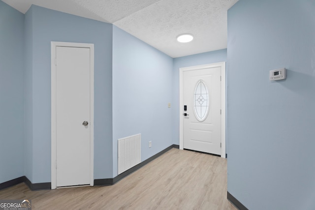 226 Old Atlanta Rd, Stockbridge, GA 30281 - foyer entrance featuring baseboards, wood finished floors, and a textured ceiling
